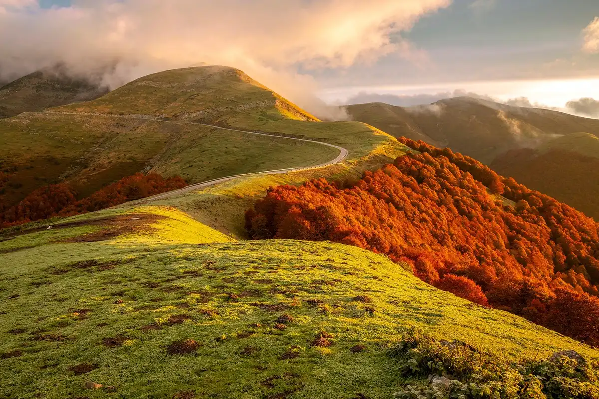 Motorcycle on a winding alpine pass with panoramic mountain views