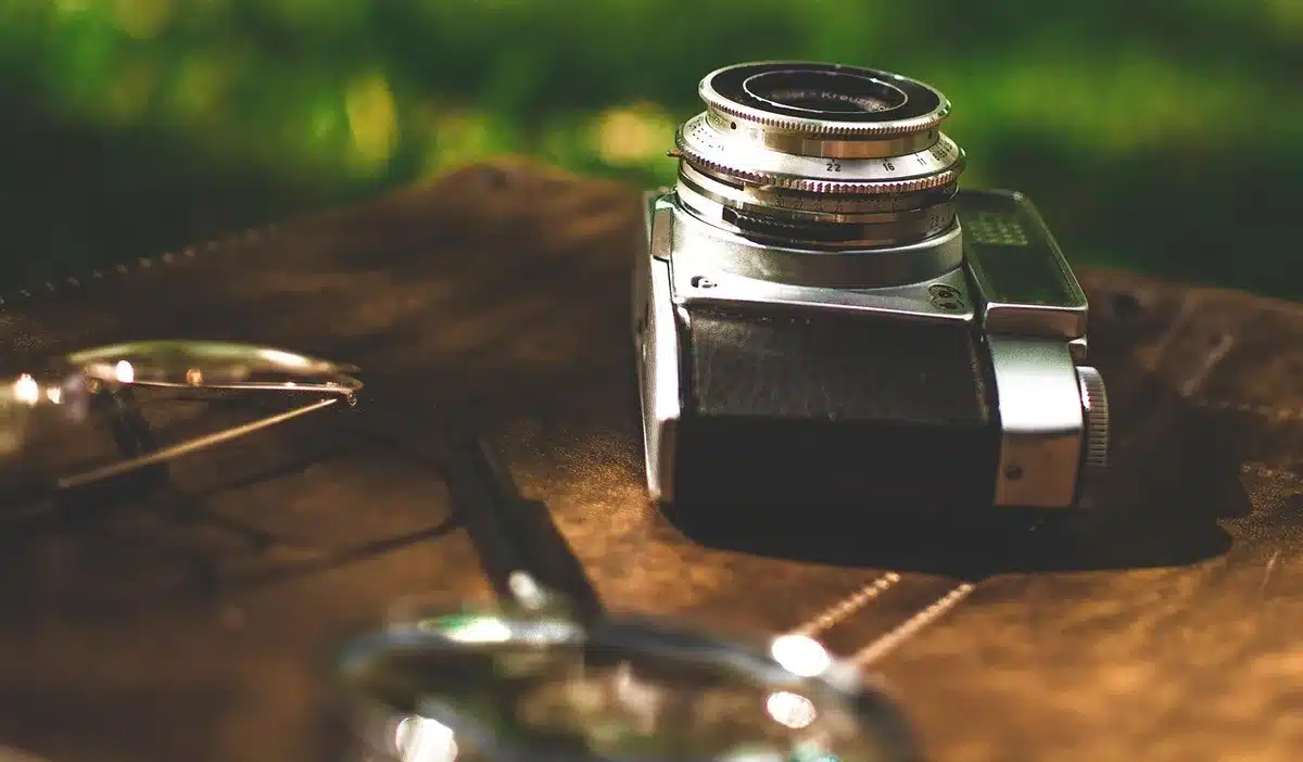 Motorcycle camera kit components laid out: batteries, microSD card and selfie stick