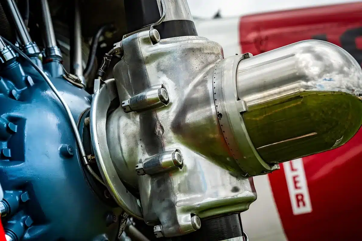 Close-up of a compact parallel-twin motorcycle engine showing cylinders and exhaust headers