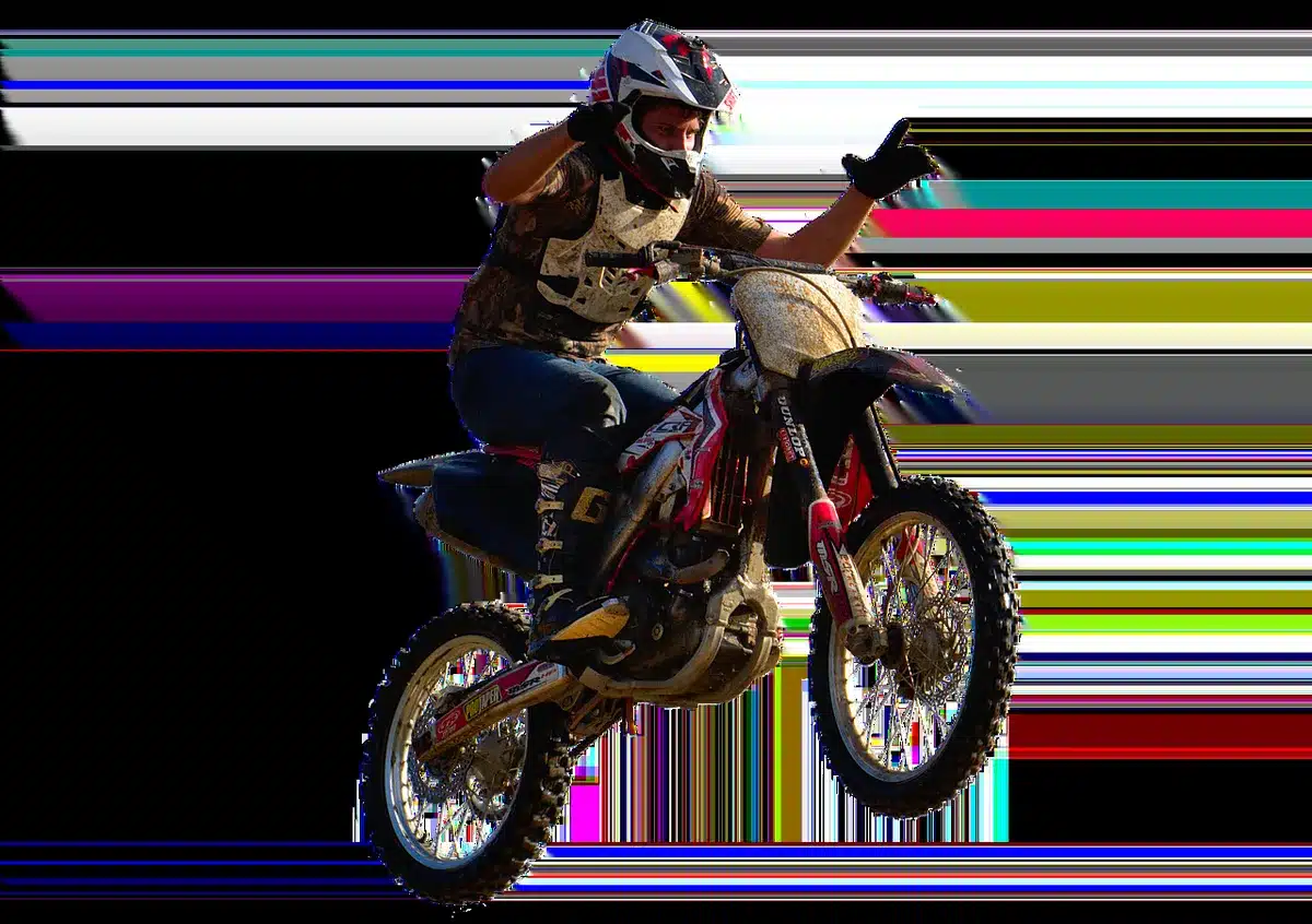 Test rider evaluating suspension on a dirt track with mechanic observing
