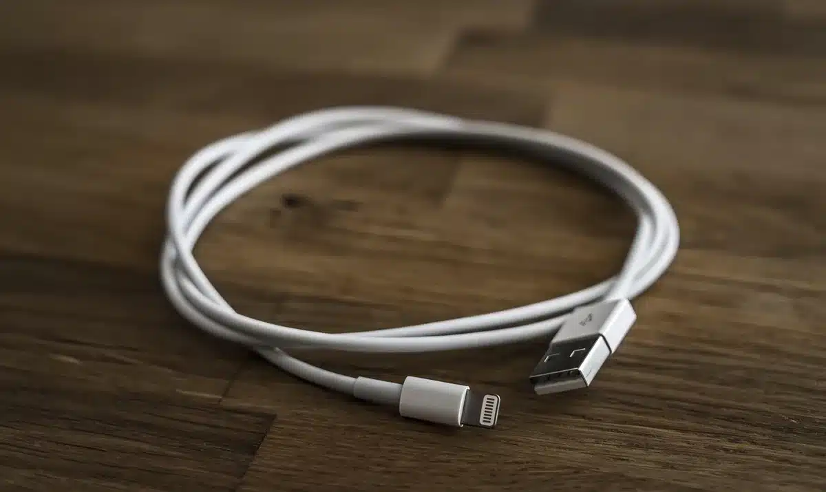 MicroSD card next to a USB-C cable and smartphone