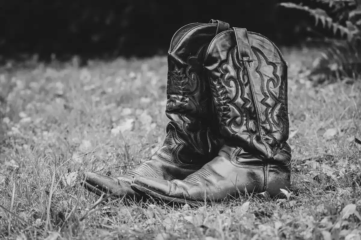Close-up of boots showing four micrometric buckles and stitching