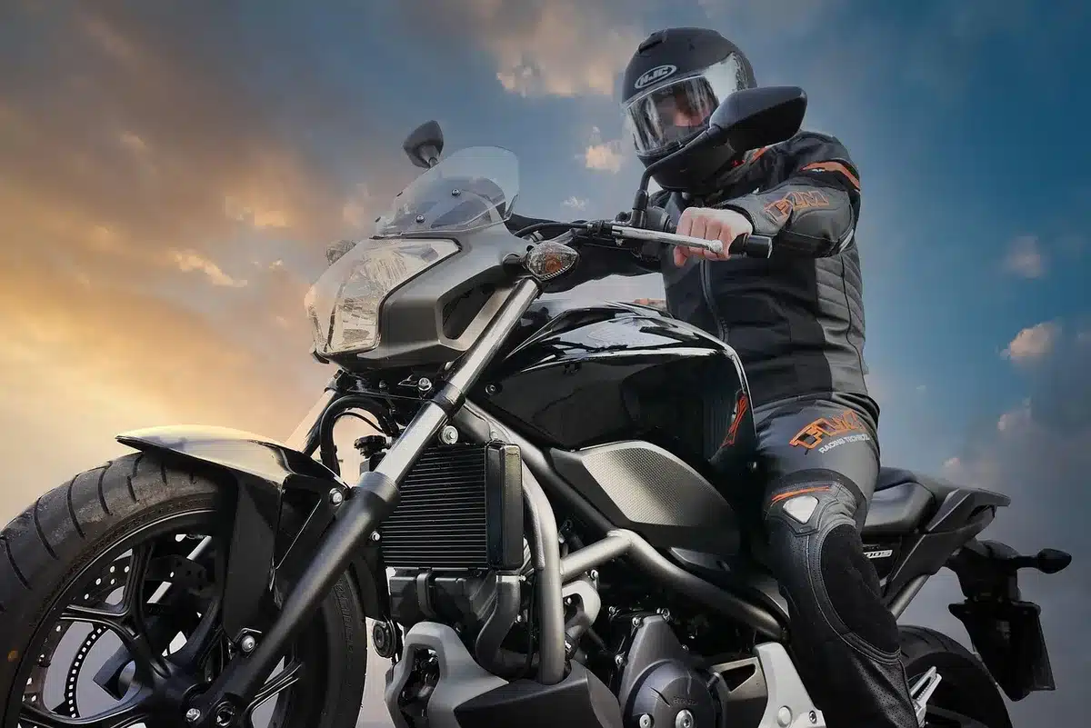 Packable motorcycle rain suit folded in a tankbag on a motorcycle