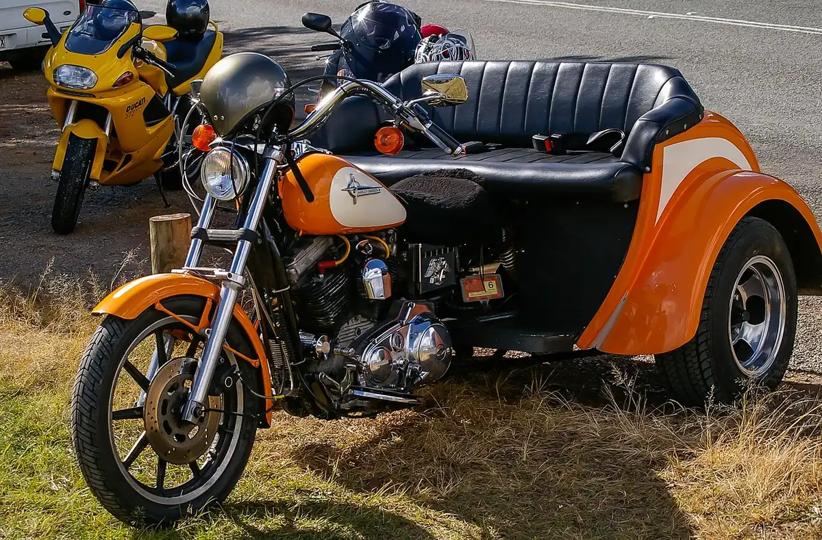 Motorcycle cockpit showing TFT display and large V-twin engine beside the tank