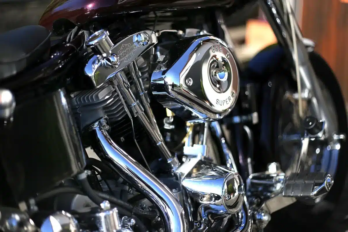 Close-up of a compact inline-four motorcycle engine and exhaust headers