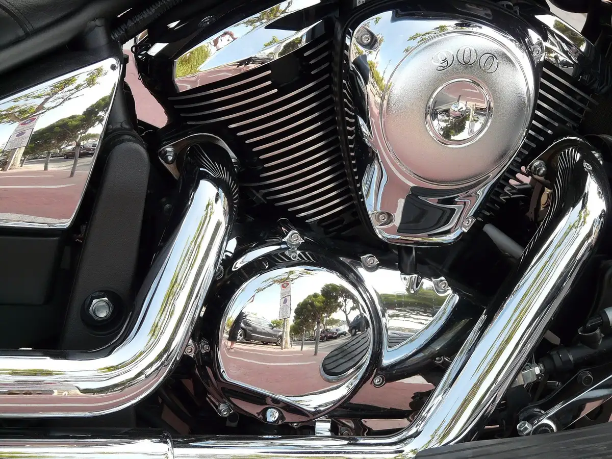 Four-into-one exhaust header feeding a large megaphone silencer on a motorcycle
