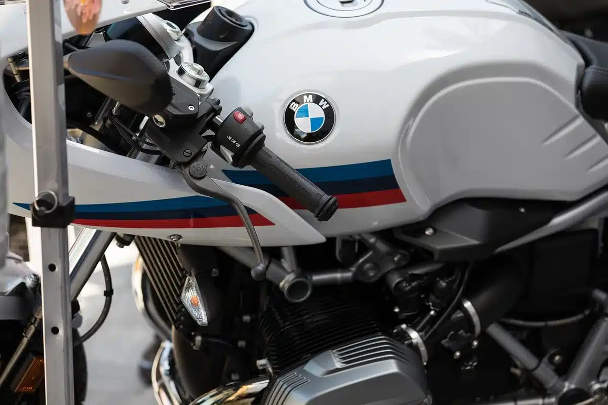 Close view of a motorcycle clutch lever and engine side cover hinting at electronic actuation