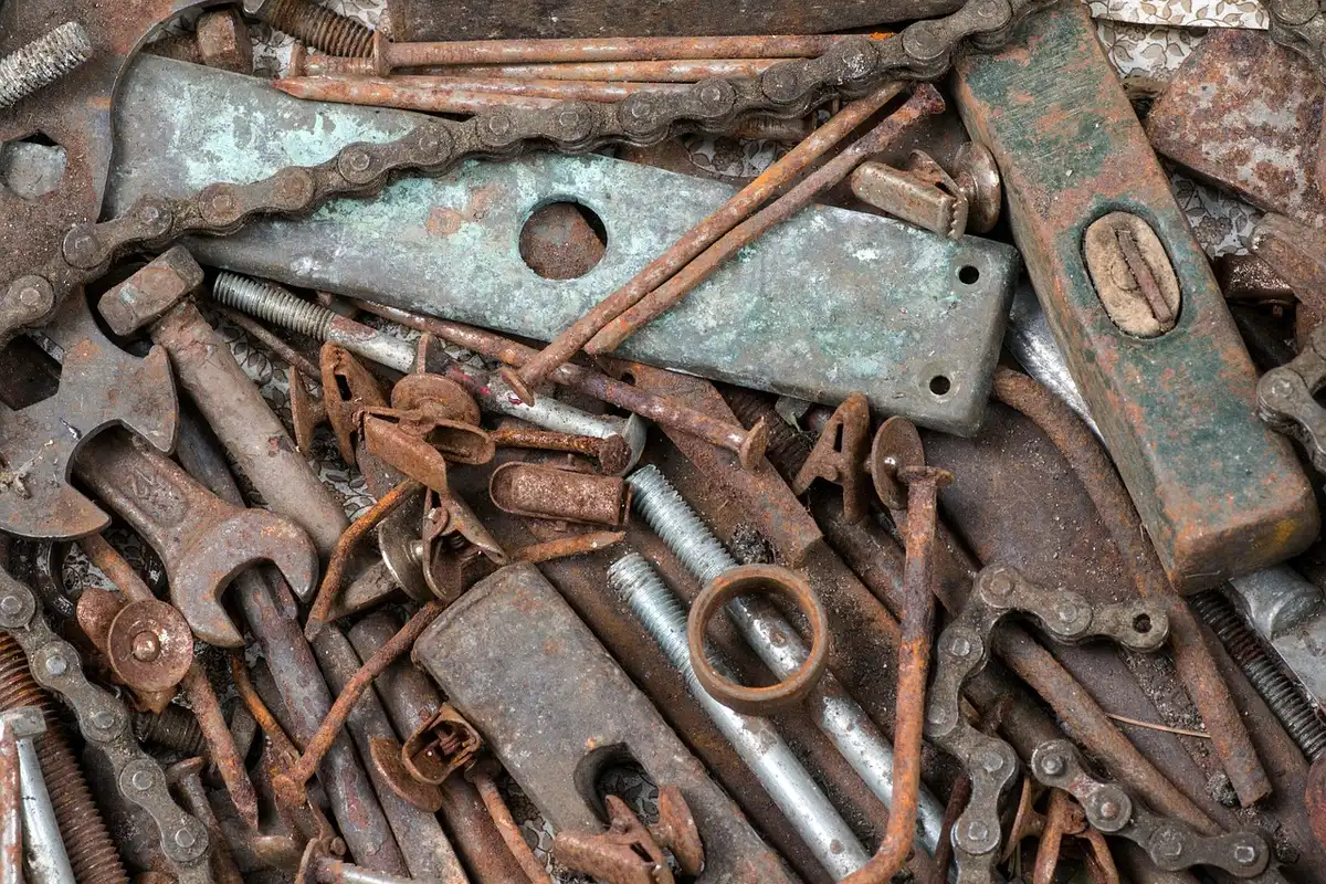 Workshop bench with motorcycle chain, tyre and tools in soft focus