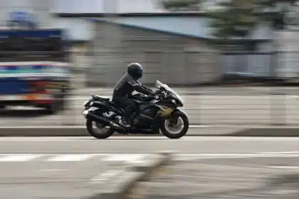 Two mechanics working on unbranded superbike fairings in a racetrack paddock
