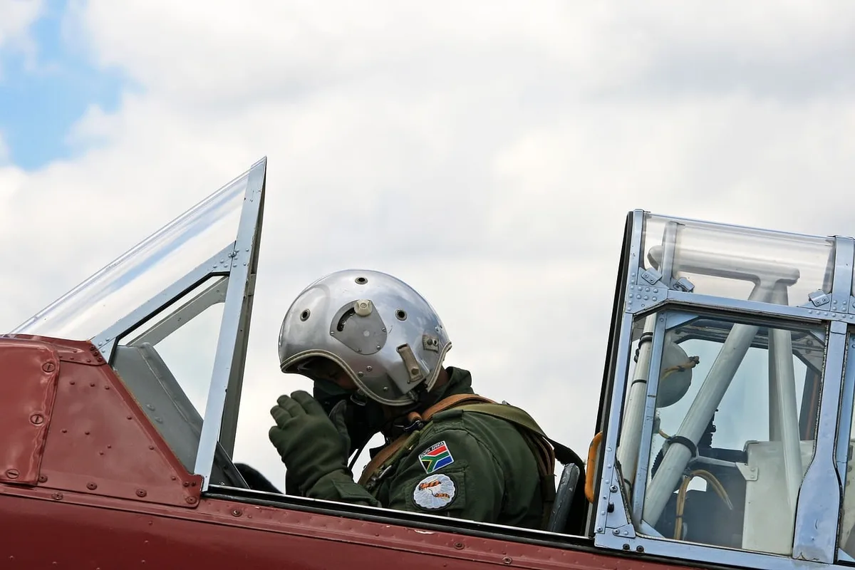Motorcycle helmet with gloves and communication headset on a workbench