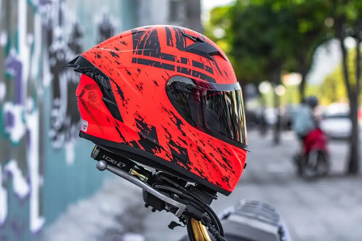 Sunlit motorcycle helmet interior with generic sunglasses on a seat