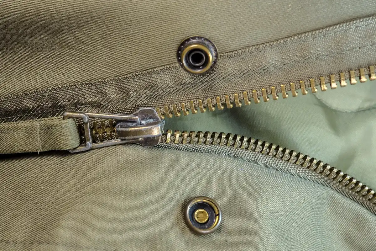 Close-up of dual zippers on a one-piece motorcycle suit being fastened