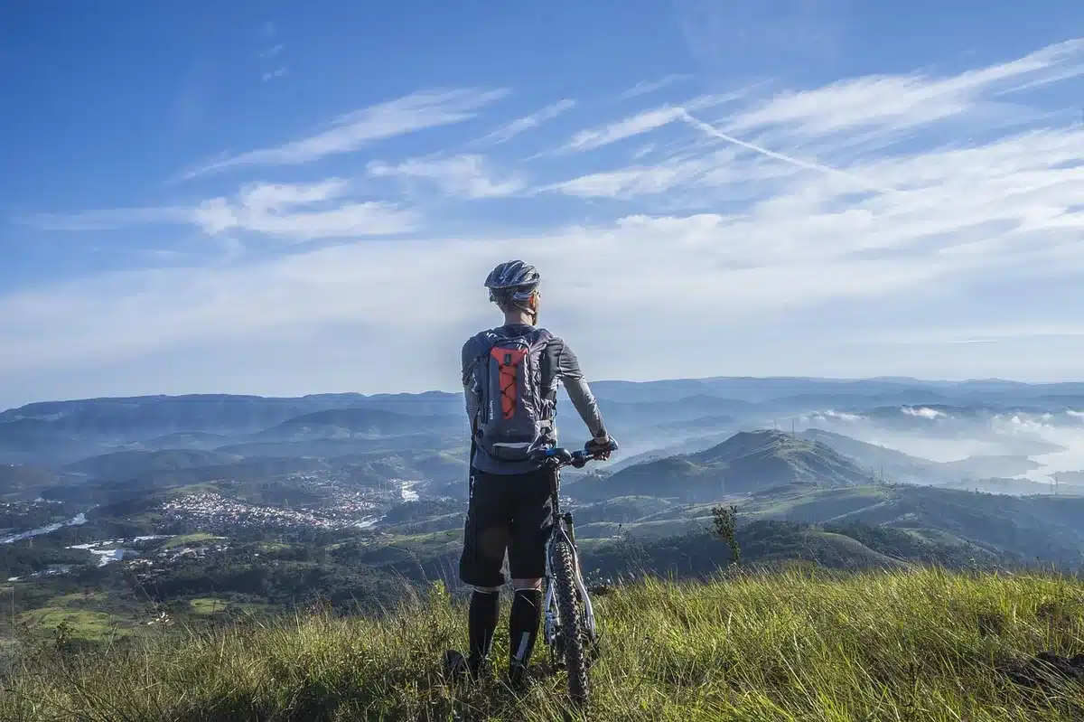 Single-track muddy trail through woodland showing varied off-road terrain